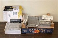 Portable cassette player/flat of tapes