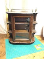 Small display cabinet with gallery on top
