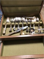 Wooden box full of assorted silverware