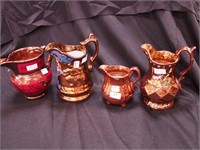 Four vintage copper lustre pitchers, ranging