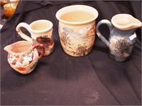 Four pieces of art pottery: jar, vase and mug