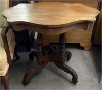 Carved Parlor Table with Ornate Base on Castors