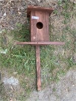 Birdhouse on a stake. About a foot tall