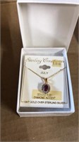 Ruby and diamond accent pendant. Gold over