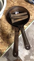 2 rusty campfire skillets and 5 railroad stakes