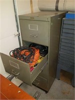 Filing cabinet full of extension cords and wood