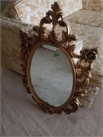 Gold coloured wall mirror plastic