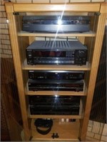 Stereo cabinet full of stereo equipment with for
