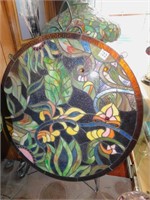 ROUND STAINED-GLASS PIECE ON EASEL THAT COULD BE