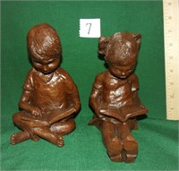 carved boy/girl figures