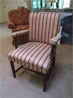 Red and White Striped Chair with Wooden Supports.