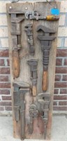 Collection of monkey wrenches on barn board