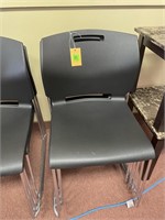 5 black stacking chairs-like new