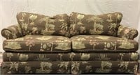 2 seat sofa in palm tree pattern upholstery, tear