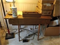 singer sewing machine in stand with manual