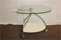 Handled glass top table with under shelf on