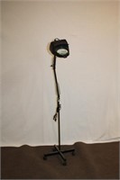 Lighted magnifying lamp on rolling stand,