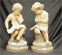 Two German bisque figures of young boys reading