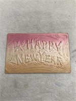 Postmark 1909 embossed happy new year postcard