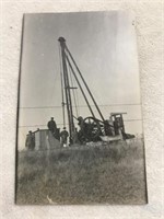 Photo postcard of men working on oil drill