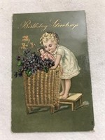 Birthday greetings postcard child with doll