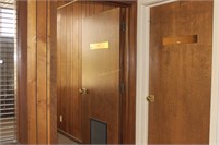 Two solid slab interior office doors with brass pl