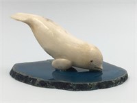 Fossilized ivory carving of a dolphin