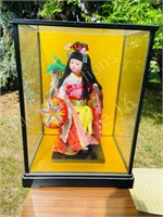 Asian dress doll in glass case
