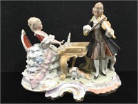 Hand Painted Porcelain Figurine. 9in. W x 7in. H.