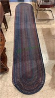 Long braided runner rug - blues and reds. Measures
