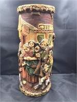 Large candle with detailed carvings of