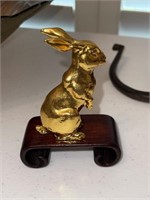 Gold plated metal bunny on wood base