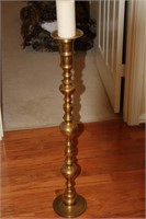 Tall brass candlestick w/ candle