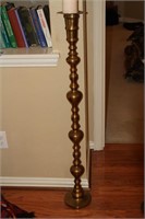 Tall brass candlestick w/ candle