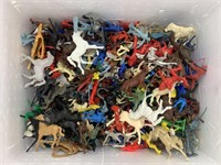 Box of plastic cowboys, soldiers and horses