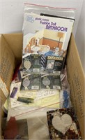 Assorted craft books, cross-stitch and