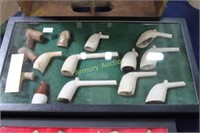 ANTIQUE CLAY PIPES IN DISPLAY CASE