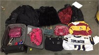 Rolling suitcase with misc clothes and bags