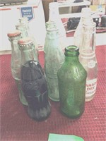 8 coca-cola bottles 1 7up. 2-can dry