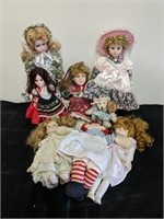 Group of porcelain dolls and 1 Raggedy Ann doll