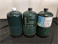Three coleman small propane tanks