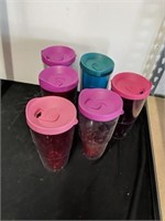 Group of lidded travel mugs/glasses