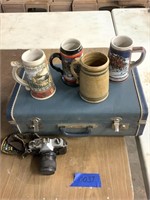 Steins, camera and suitcase