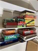 Two Shelves of puzzles and games.