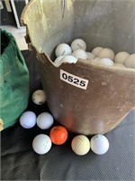 Bucket & a bag of used golf balls.