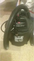 Black Shop-Vac and box of vacuum parts