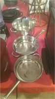 Group of 3 stainless kitchen pans and one glass