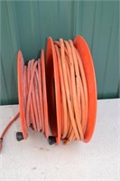 2 spools of extension cords, one being 12ga.