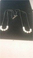 Pair of pearl necklaces with gold tone chains