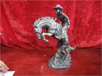Cowboy on rearing horse statue.